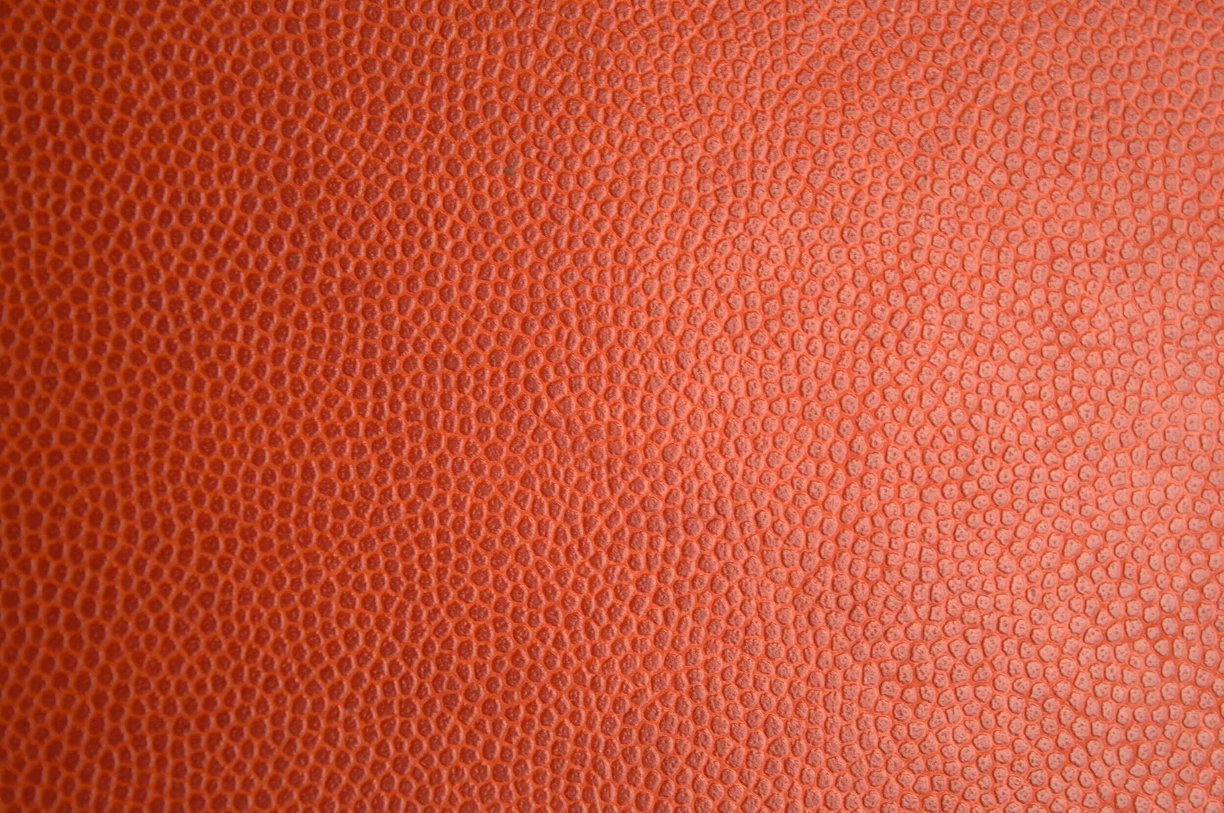 Detailne makrofotograafia oranžist nahatekstuurist, ideaalne taustaks või materjalideks.