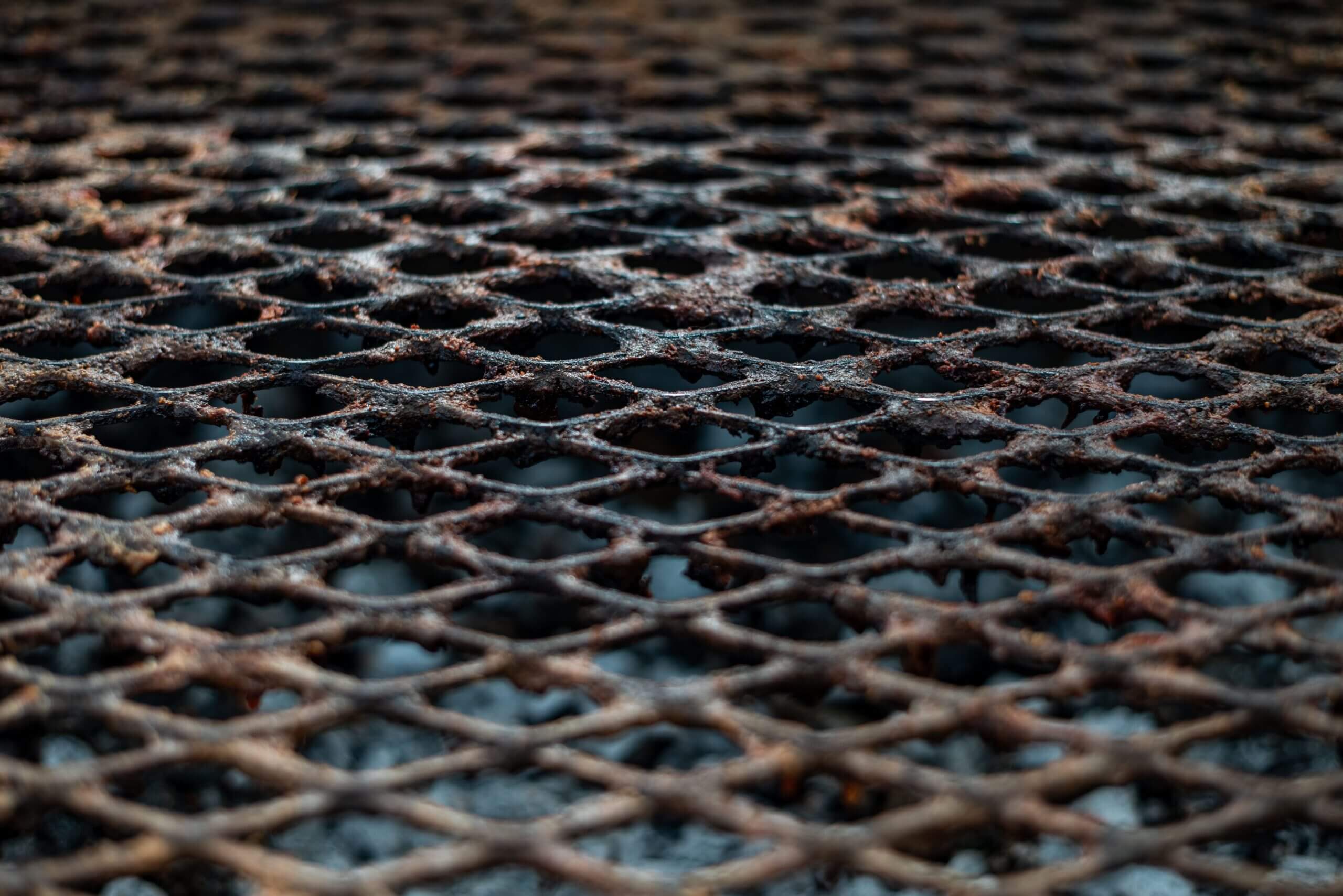 A detailed close-up of a rusty grill surface, emphasizing texture and rustic appeal.