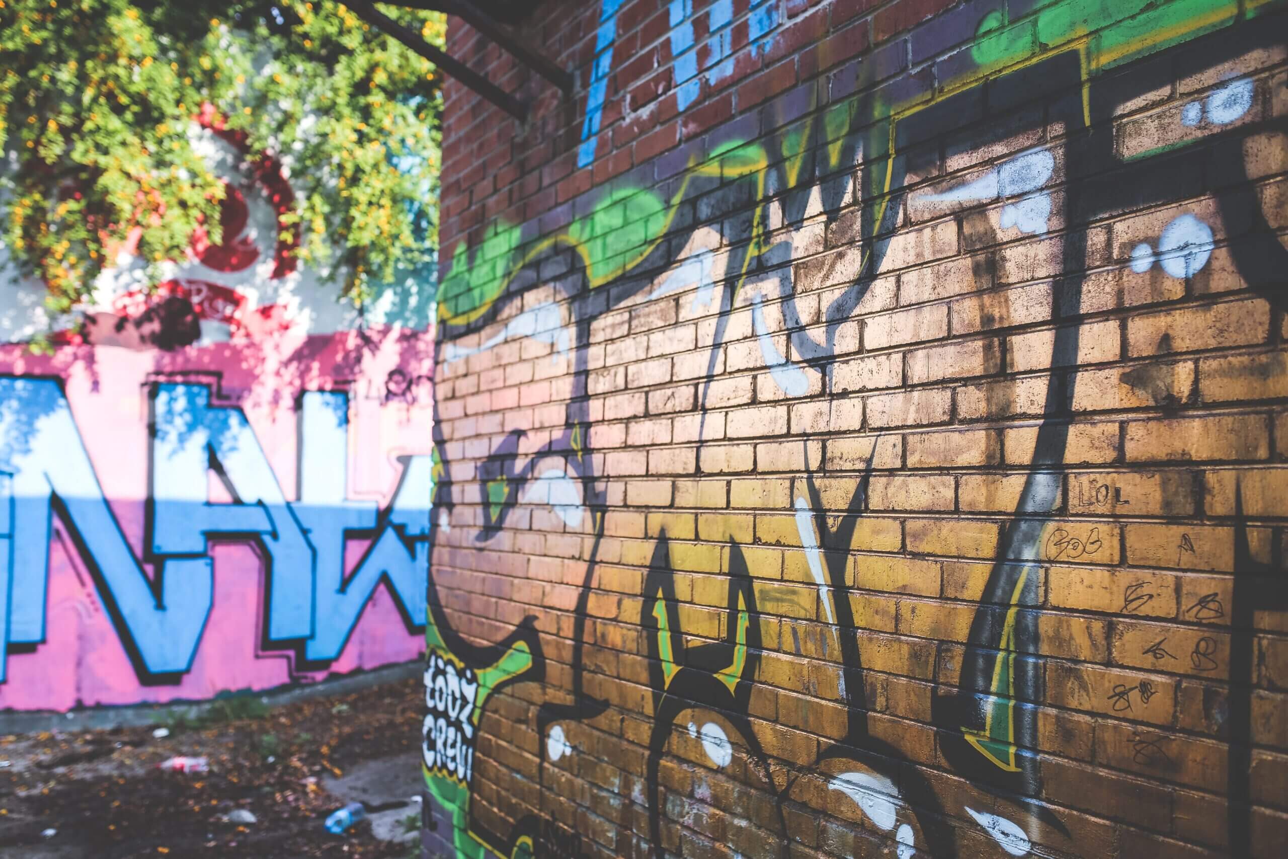 Vibrant street art on a brick wall showcasing urban creativity and design.